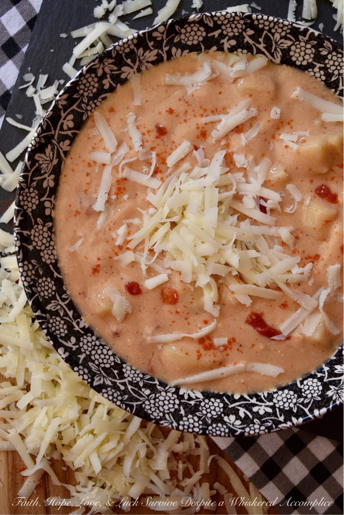 Southern Pimento Cheese Crockpot Potato Soup - If you're looking for a quick southern-inspired, easy-to-make, weekday bowl of creamy potato soup, then this is your recipe. Simply dump the soup ingredients into a crockpot and stir to combine. Eight hours later, purée half of the soup in a blender and then garnish each bowl of pimento cheese potato soup with some freshly grated white cheddar cheese right before serving. What could be more simple, or more delicious?