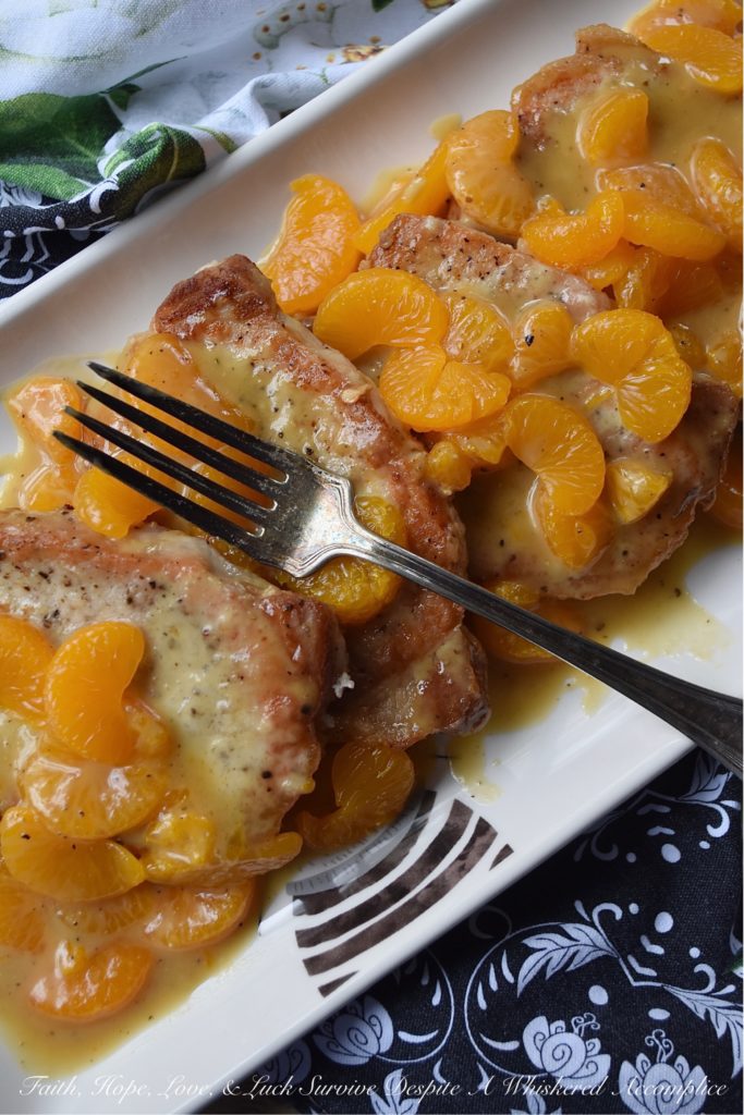 Mandarin Orange Honey Mustard Pork Chops - This may be one of the easiest fried pork chop recipes in the world. A little bit of salt and pepper, a quick flour dredge, and then a quick and easy pan fry in olive oil makes these pork chops the perfect option for a busy weeknight meal. And, once they are topped with a delicious mandarin orange honey mustard sauce, your mouth and your stomach are going to totally fall in love.