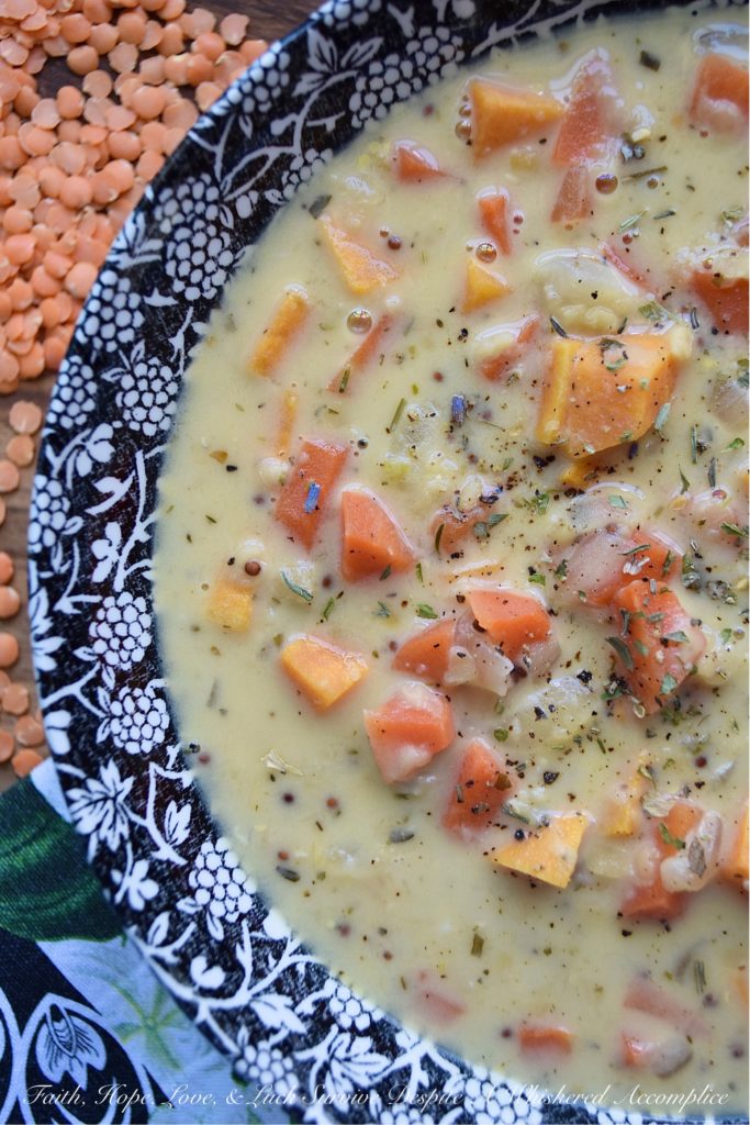 Creamy French Red Lentil Soup with Ham Stock - Instead of tossing out your leftover holiday ham bone, why not use it to make this creamy red lentil soup instead? After all, why should you waste all of that delicious salty ham flavor, when you can use it to make this red lentil, carrot, and sweet potato soup, seasoned with Herbes de Provence? This French-inspired red lentil soup is bound to become an after-the-holiday new family favorite recipe.