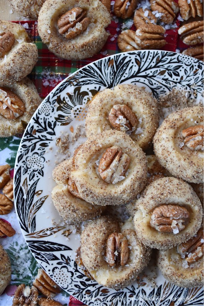 Salted Honey Pecan Thumbprint Cookies - What could be better than a buttery thumbprint cookie? A buttery thumbprint cookie rolled in finely ground pecans, topped with a pecan half, and then drizzled with just the right touch of sweet honey and a light sprinkle of flaky sea salt. This is one sweet and salty thumbprint cookie you simply won't be able to resist.