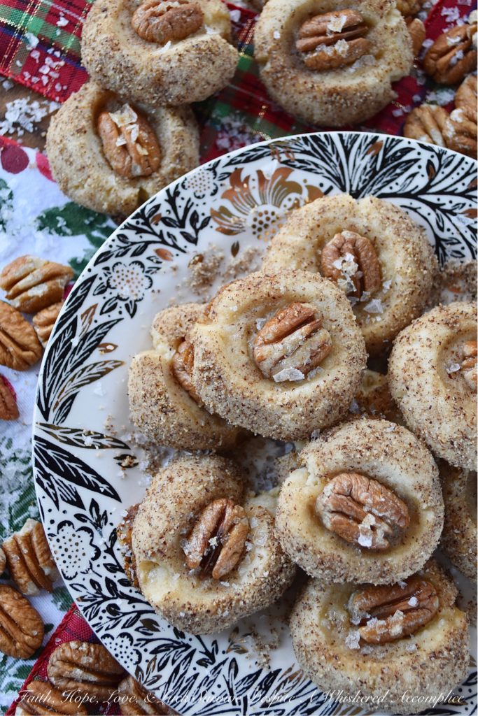 Salted Honey Pecan Thumbprint Cookies - What could be better than a buttery thumbprint cookie? A buttery thumbprint cookie rolled in finely ground pecans, topped with a pecan half, and then drizzled with just the right touch of sweet honey and a light sprinkle of flaky sea salt. This is one sweet and salty thumbprint cookie you simply won't be able to resist.