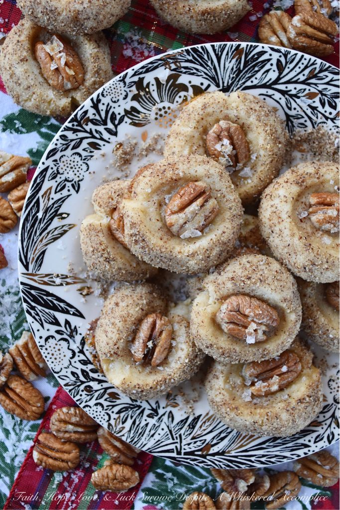 Salted Honey Pecan Thumbprint Cookies - What could be better than a buttery thumbprint cookie? A buttery thumbprint cookie rolled in finely ground pecans, topped with a pecan half, and then drizzled with just the right touch of sweet honey and a light sprinkle of flaky sea salt. This is one sweet and salty thumbprint cookie you simply won't be able to resist.