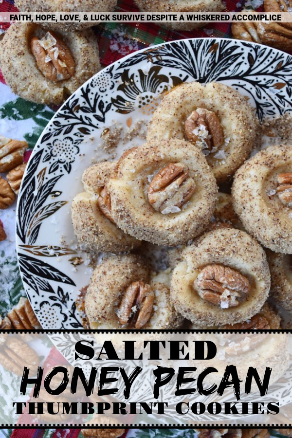 Salted Honey Pecan Thumbprint Cookies - What could be better than a buttery thumbprint cookie? A buttery thumbprint cookie rolled in finely ground pecans, topped with a pecan half, and then drizzled with just the right touch of sweet honey and a light sprinkle of flaky sea salt. This is one sweet and salty thumbprint cookie you simply won't be able to resist.