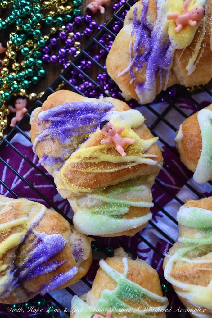 Mardi Gras Cream Cheese King Cake Croissants - Unable to find a king cake to celebrate Mardi Gras this year? With these cream cheese croissants, made using refrigerated crescent rolls, you'll be able to celebrate the holiday with very little effort involved. And, once you decorate each king cake croissant with some yellow, green, and purple sanding sugar and a small plastic Mardi Gras baby, you'll have a festive treat everyone in your family will love. Laissez les bons temps rouler.