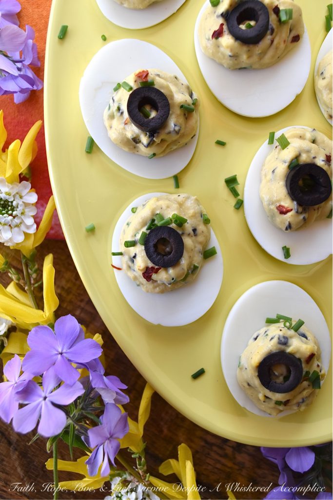 Chunky Sweet & Spicy Black Olive Deviled Eggs - Most deviled eggs have a creamy filling, however, with these deviled eggs, finely chopped black olives give the deviled egg filling a delightful chunky texture. And, once you add a little dijon mustard, honey, crushed red pepper flakes, black pepper, chives, and mayonnaise, I think you'll be quite impressed with the lovely sweet and spicy flavor of these chunky black olive deviled eggs.