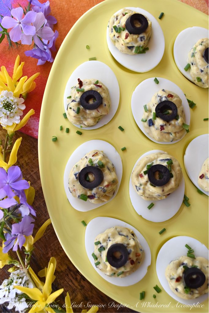Chunky Sweet & Spicy Black Olive Deviled Eggs - Most deviled eggs have a creamy filling, however, with these deviled eggs, finely chopped black olives give the deviled egg filling a delightful chunky texture. And, once you add a little dijon mustard, honey, crushed red pepper flakes, black pepper, chives, and mayonnaise, I think you'll be quite impressed with the lovely sweet and spicy flavor of these chunky black olive deviled eggs.
