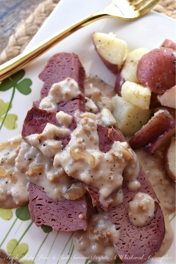 Crockpot Corned Beef with Stout & Onion Gravy - Are you looking for a new recipe to help you celebrate St. Patrick's Day? A recipe that can be made in a crockpot? Say hello to your new favorite way to cook corned beef. After the corned beef brisket slowly cooks for several hours in a crockpot, you use the crockpot cooking liquid and the strained crockpot ingredients to make a quick, simple, easy, and absolutely delicious creamy stout and onion gravy. Get ready to have your shamrocks rocked by this amazing gravy-smothered crockpot corned beef.
