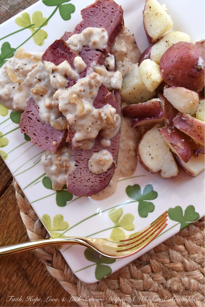 Crockpot Corned Beef with Stout & Onion Gravy - Are you looking for a new recipe to help you celebrate St. Patrick's Day? A recipe that can be made in a crockpot? Say hello to your new favorite way to cook corned beef. After the corned beef brisket slowly cooks for several hours in a crockpot, you use the crockpot cooking liquid and the strained crockpot ingredients to make a quick, simple, easy, and absolutely delicious creamy stout and onion gravy. Get ready to have your shamrocks rocked by this amazing gravy-smothered crockpot corned beef.