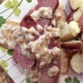 Crockpot Corned Beef with Stout & Onion Gravy - Are you looking for a new recipe to help you celebrate St. Patrick's Day? A recipe that can be made in a crockpot? Say hello to your new favorite way to cook corned beef. After the corned beef brisket slowly cooks for several hours in a crockpot, you use the crockpot cooking liquid and the strained crockpot ingredients to make a quick, simple, easy, and absolutely delicious creamy stout and onion gravy. Get ready to have your shamrocks rocked by this amazing gravy-smothered crockpot corned beef.