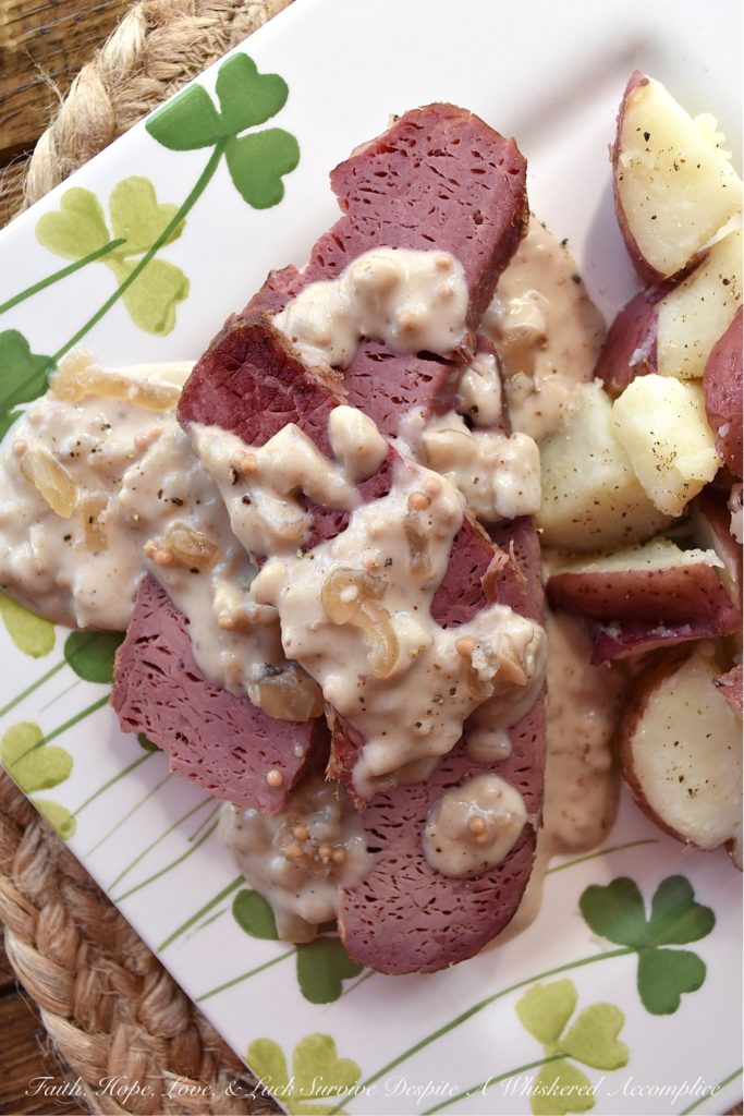 Crockpot Corned Beef with Stout & Onion Gravy - Are you looking for a new recipe to help you celebrate St. Patrick's Day? A recipe that can be made in a crockpot? Say hello to your new favorite way to cook corned beef. After the corned beef brisket slowly cooks for several hours in a crockpot, you use the crockpot cooking liquid and the strained crockpot ingredients to make a quick, simple, easy, and absolutely delicious creamy stout and onion gravy. Get ready to have your shamrocks rocked by this amazing gravy-smothered crockpot corned beef.