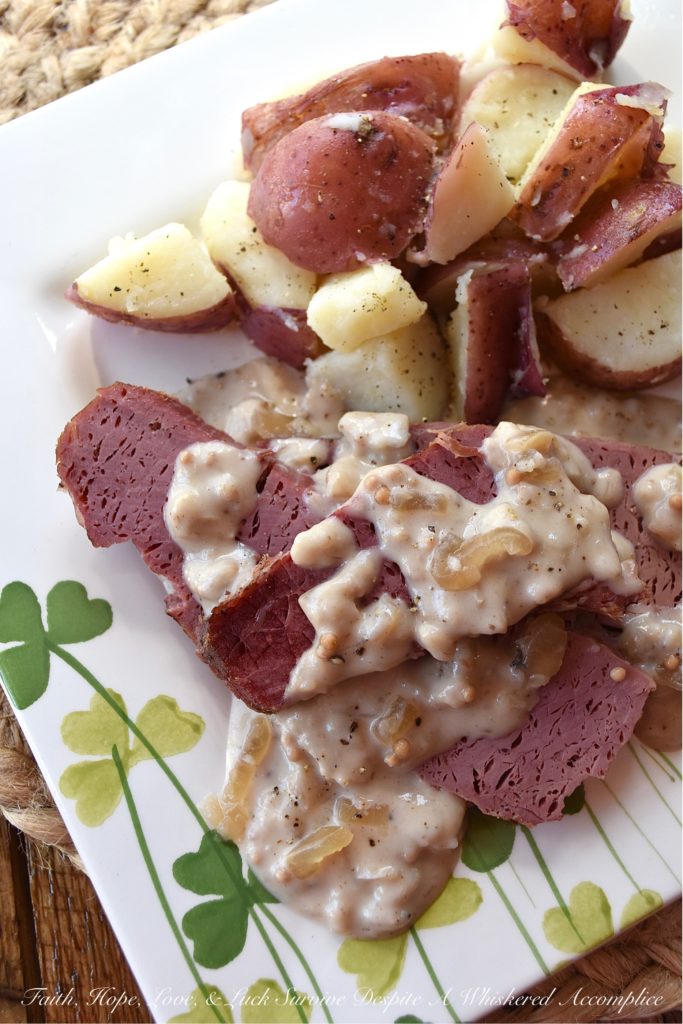 Crockpot Corned Beef with Stout & Onion Gravy - Are you looking for a new recipe to help you celebrate St. Patrick's Day? A recipe that can be made in a crockpot? Say hello to your new favorite way to cook corned beef. After the corned beef brisket slowly cooks for several hours in a crockpot, you use the crockpot cooking liquid and the strained crockpot ingredients to make a quick, simple, easy, and absolutely delicious creamy stout and onion gravy. Get ready to have your shamrocks rocked by this amazing gravy-smothered crockpot corned beef.