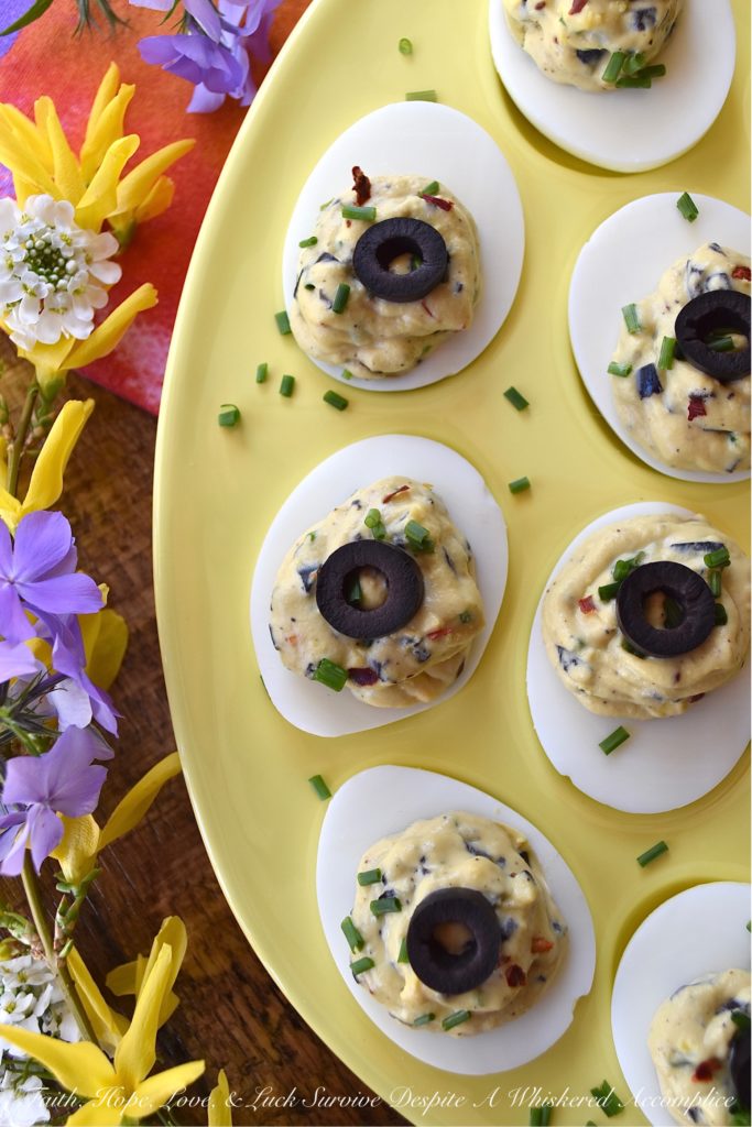Chunky Sweet & Spicy Black Olive Deviled Eggs - Most deviled eggs have a creamy filling, however, with these deviled eggs, finely chopped black olives give the deviled egg filling a delightful chunky texture. And, once you add a little dijon mustard, honey, crushed red pepper flakes, black pepper, chives, and mayonnaise, I think you'll be quite impressed with the lovely sweet and spicy flavor of these chunky black olive deviled eggs.