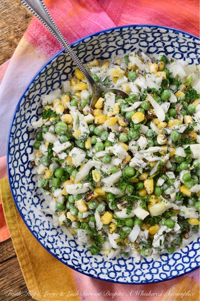 Buttermilk Corn, Pea, & Fennel Ranch Salad - Fresh vegetables aren't always available when it comes to making a creamy, well-seasoned, crunchy vegetable side dish. So, with this buttermilk ranch salad, frozen vegetables come to the rescue. Perfectly cooked frozen corn and peas are mixed with a homemade herby buttermilk dressing. Then, a chopped bulb of fennel is added to create just the right amount of crunch and flavor to make this salad one of the most delicious frozen vegetable side dishes you'll ever taste.