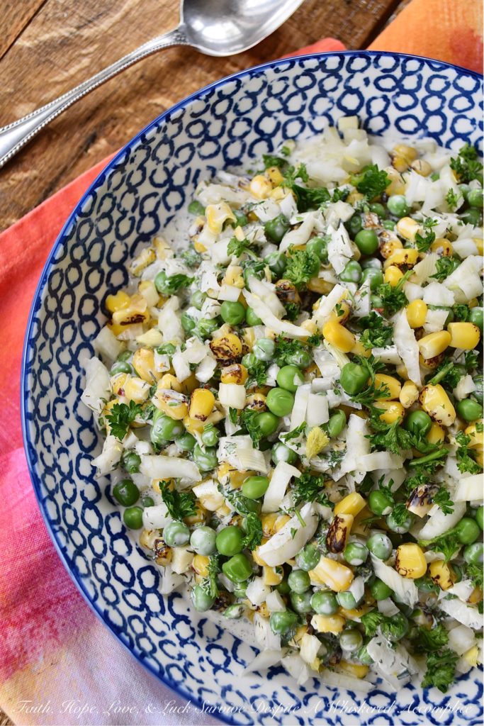 Buttermilk Corn, Pea, & Fennel Ranch Salad - Fresh vegetables aren't always available when it comes to making a creamy, well-seasoned, crunchy vegetable side dish. So, with this buttermilk ranch salad, frozen vegetables come to the rescue. Perfectly cooked frozen corn and peas are mixed with a homemade herby buttermilk dressing. Then, a chopped bulb of fennel is added to create just the right amount of crunch and flavor to make this salad one of the most delicious frozen vegetable side dishes you'll ever taste.