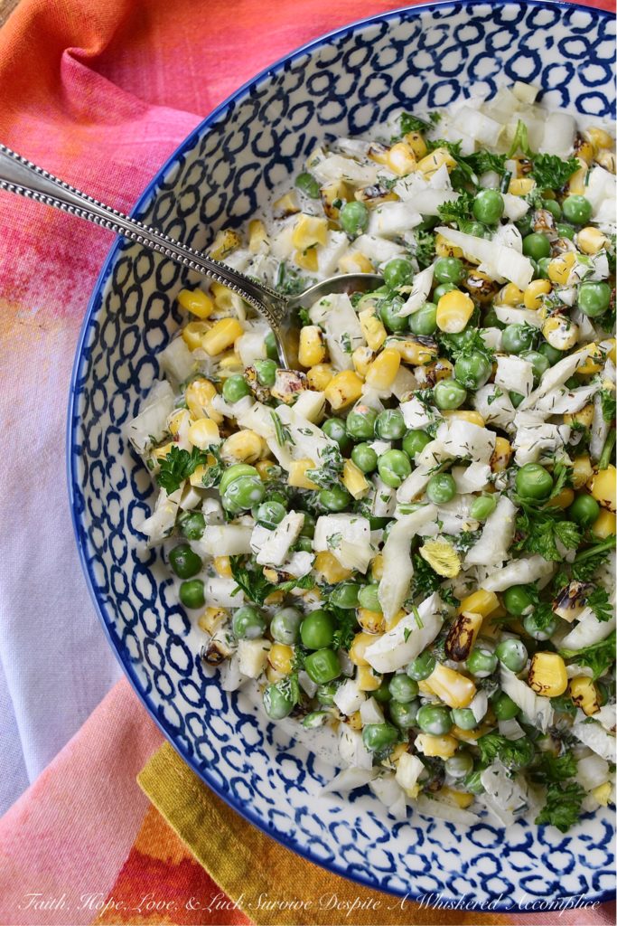 Buttermilk Corn, Pea, & Fennel Ranch Salad - Fresh vegetables aren't always available when it comes to making a creamy, well-seasoned, crunchy vegetable side dish. So, with this buttermilk ranch salad, frozen vegetables come to the rescue. Perfectly cooked frozen corn and peas are mixed with a homemade herby buttermilk dressing. Then, a chopped bulb of fennel is added to create just the right amount of crunch and flavor to make this salad one of the most delicious frozen vegetable side dishes you'll ever taste.