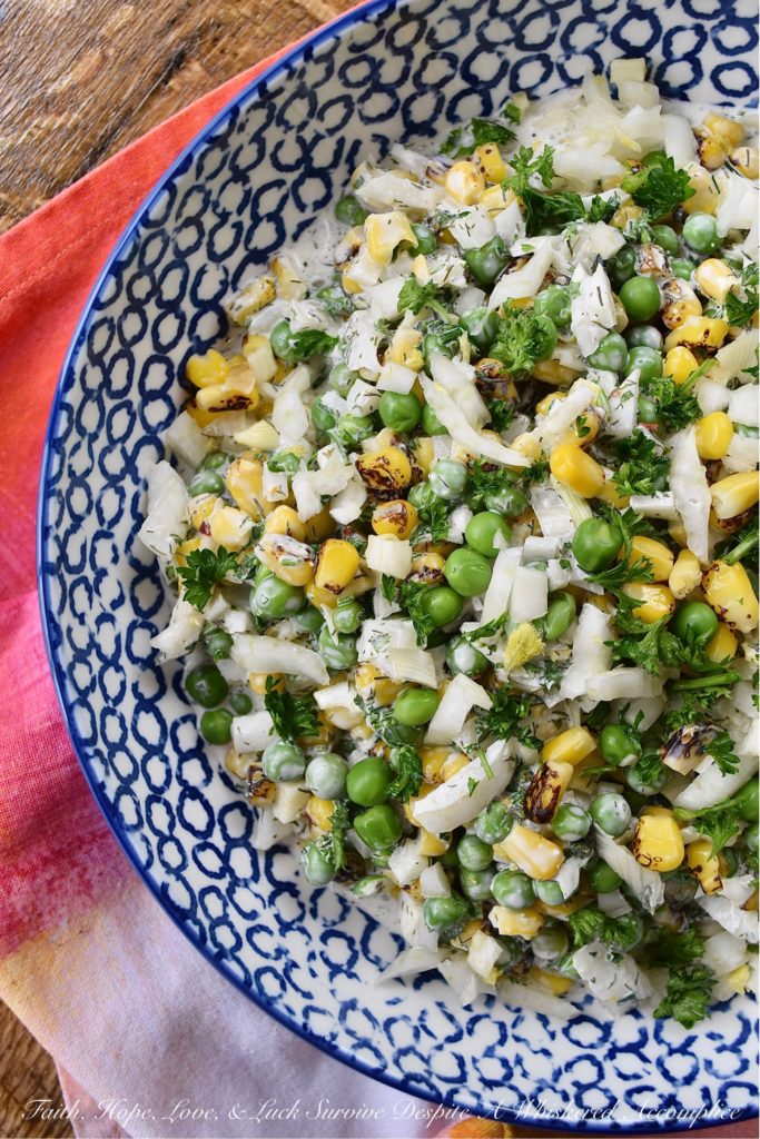 Buttermilk Corn, Pea, & Fennel Ranch Salad - Fresh vegetables aren't always available when it comes to making a creamy, well-seasoned, crunchy vegetable side dish. So, with this buttermilk ranch salad, frozen vegetables come to the rescue. Perfectly cooked frozen corn and peas are mixed with a homemade herby buttermilk dressing. Then, a chopped bulb of fennel is added to create just the right amount of crunch and flavor to make this salad one of the most delicious frozen vegetable side dishes you'll ever taste.