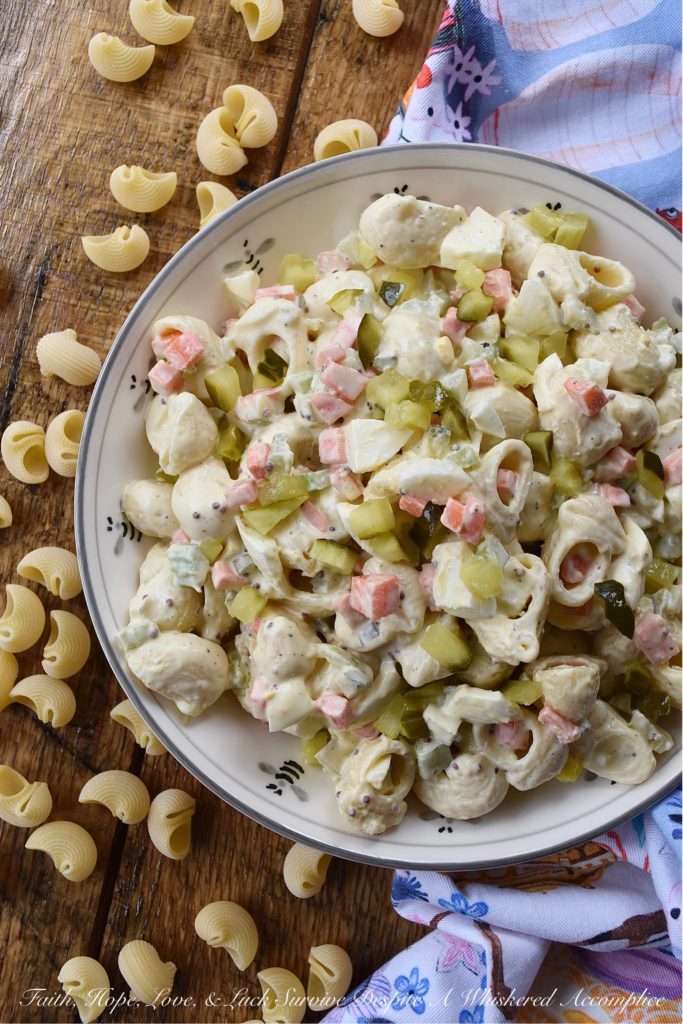 Bread & Butter Pickle Amish Macaroni Salad - Are you looking for a macaroni salad that is both sweet and tangy? Well then, this Amish macaroni salad recipe is just what you've been searching for. Finely chopped celery, carrot, and hard-boiled egg add lots of great texture while bread and butter pickles give this creamy pasta salad just the right hint of sweet vinegary flavor. Basically, this Amish macaroni salad has everything you could ever want in a pasta salad and more.