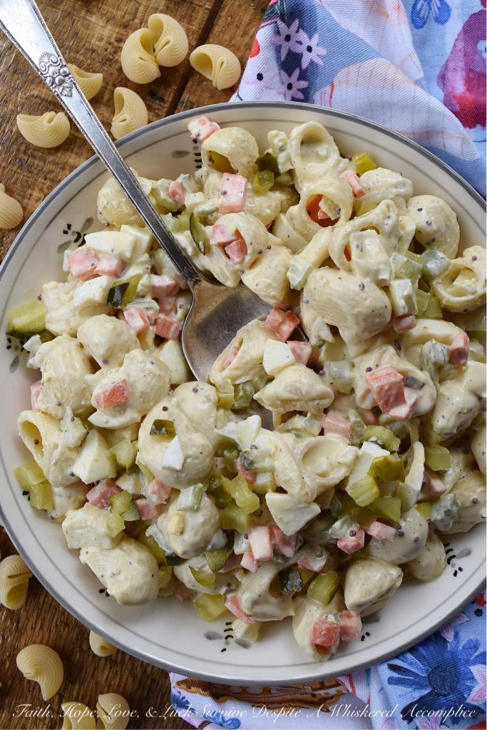 Bread & Butter Pickle Amish Macaroni Salad - Are you looking for a macaroni salad that is both sweet and tangy? Well then, this Amish macaroni salad recipe is just what you've been searching for. Finely chopped celery, carrot, and hard-boiled egg add lots of great texture while bread and butter pickles give this creamy pasta salad just the right hint of sweet vinegary flavor. Basically, this Amish macaroni salad has everything you could ever want in a pasta salad and more.