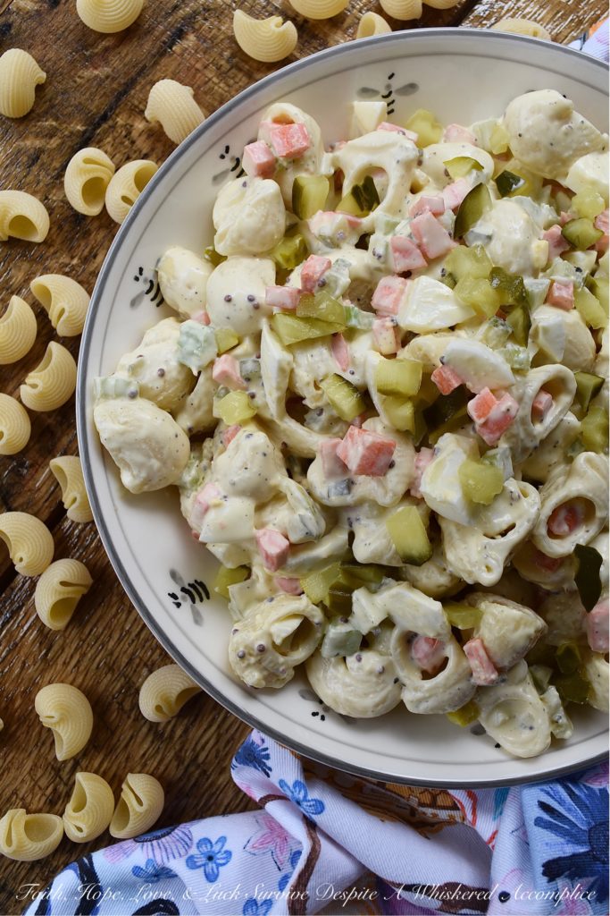 Bread & Butter Pickle Amish Macaroni Salad - Are you looking for a macaroni salad that is both sweet and tangy? Well then, this Amish macaroni salad recipe is just what you've been searching for. Finely chopped celery, carrot, and hard-boiled egg add lots of great texture while bread and butter pickles give this creamy pasta salad just the right hint of sweet vinegary flavor. Basically, this Amish macaroni salad has everything you could ever want in a pasta salad and more.