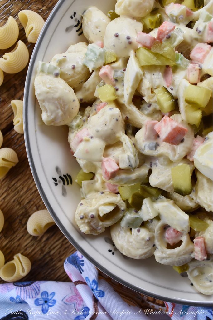 Bread & Butter Pickle Amish Macaroni Salad - Are you looking for a macaroni salad that is both sweet and tangy? Well then, this Amish macaroni salad recipe is just what you've been searching for. Finely chopped celery, carrot, and hard-boiled egg add lots of great texture while bread and butter pickles give this creamy pasta salad just the right hint of sweet vinegary flavor. Basically, this Amish macaroni salad has everything you could ever want in a pasta salad and more.