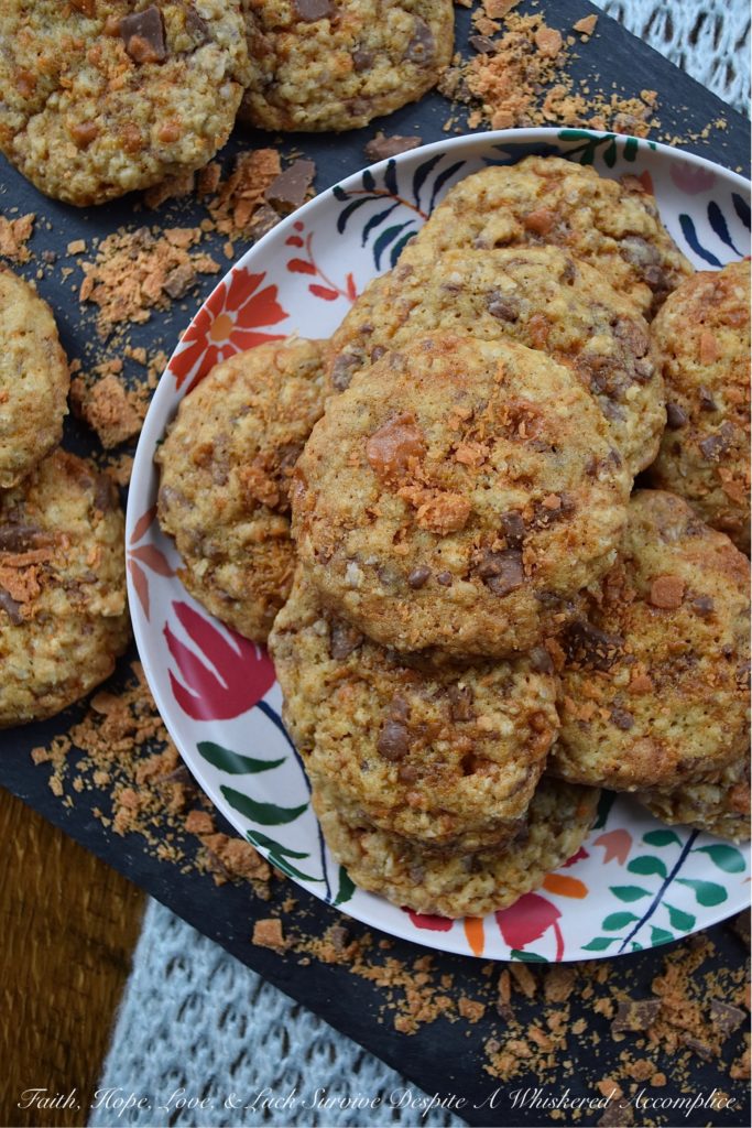 Oatmeal Butterfinger Candy Bar Cookies - Almost everyone loves an oatmeal cookie with chocolate chips or chocolate chunks folded into it. But why settle for just chocolate, when you can have both peanut butter and chocolate? These sweet and buttery, incredibly delicious oatmeal cookies are absolutely overflowing with small crunchy bits of finely chopped Butterfinger candy bar, making them the perfect chocolate and peanut butter-filled oatmeal cookie. One bite and you'll be swooning over their lovely taste and texture.