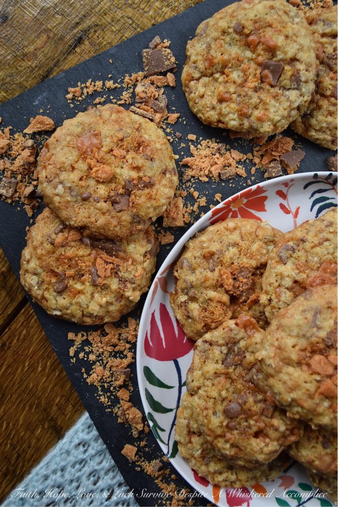 Oatmeal Butterfinger Candy Bar Cookies - Almost everyone loves an oatmeal cookie with chocolate chips or chocolate chunks folded into it. But why settle for just chocolate, when you can have both peanut butter and chocolate? These sweet and buttery, incredibly delicious oatmeal cookies are absolutely overflowing with small crunchy bits of finely chopped Butterfinger candy bar, making them the perfect chocolate and peanut butter-filled oatmeal cookie. One bite and you'll be swooning over their lovely taste and texture.