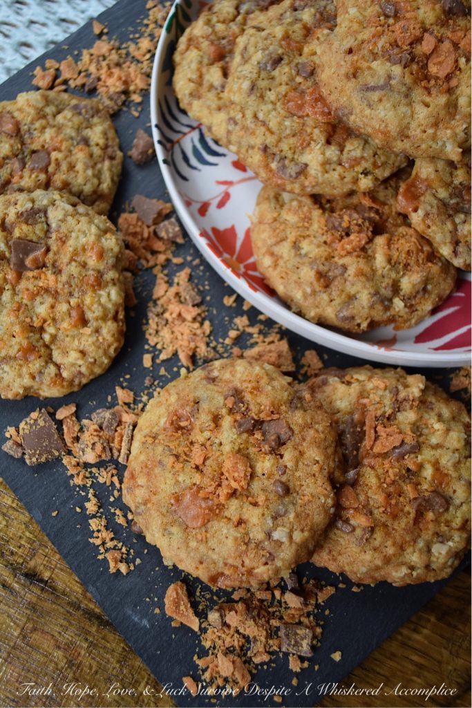 Oatmeal Butterfinger Candy Bar Cookies - Almost everyone loves an oatmeal cookie with chocolate chips or chocolate chunks folded into it. But why settle for just chocolate, when you can have both peanut butter and chocolate? These sweet and buttery, incredibly delicious oatmeal cookies are absolutely overflowing with small crunchy bits of finely chopped Butterfinger candy bar, making them the perfect chocolate and peanut butter-filled oatmeal cookie. One bite and you'll be swooning over their lovely taste and texture.