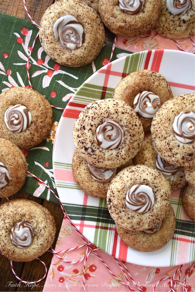 Cappuccino Swirl Butter Cookies - These amazing cappuccino swirl butter cookies are definitely a sweet treat your entire family will enjoy. They have just the right hint of coffee flavor, thanks to the espresso powder and sugar mixture they are rolled in before baking. And, once a Hershey's Kisses Hug is added to each cookie after baking, and then gently swirled after a few minutes of melting, these tasty, buttery, and delicious cookies definitely resemble an irresistible cup of fragrant cappuccino. Seriously, what's not to love bout this amazing cookie combination?