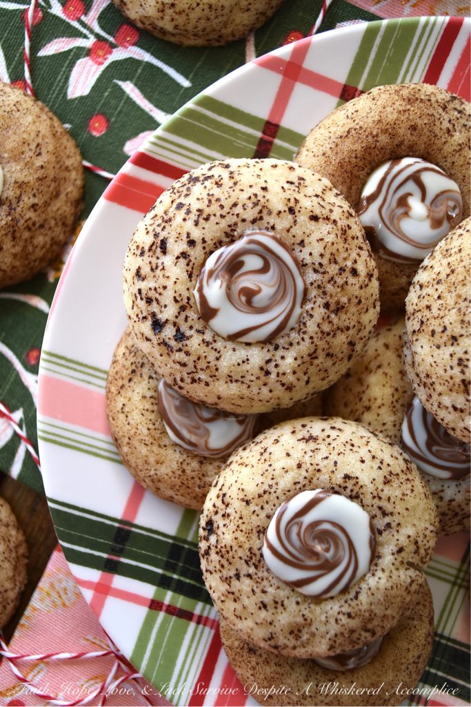 Cappuccino Swirl Butter Cookies - These amazing cappuccino swirl butter cookies are definitely a sweet treat your entire family will enjoy. They have just the right hint of coffee flavor, thanks to the espresso powder and sugar mixture they are rolled in before baking. And, once a Hershey's Kisses Hug is added to each cookie after baking, and then gently swirled after a few minutes of melting, these tasty, buttery, and delicious cookies definitely resemble an irresistible cup of fragrant cappuccino. Seriously, what's not to love bout this amazing cookie combination?