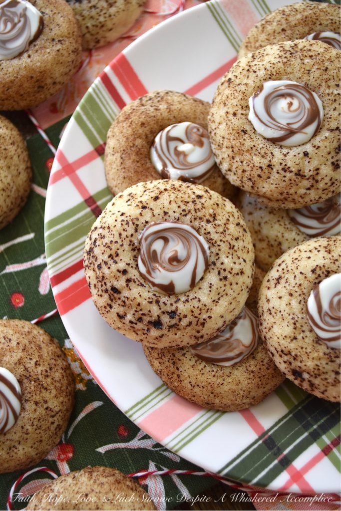 Cappuccino Swirl Butter Cookies - These amazing cappuccino swirl butter cookies are definitely a sweet treat your entire family will enjoy. They have just the right hint of coffee flavor, thanks to the espresso powder and sugar mixture they are rolled in before baking. And, once a Hershey's Kisses Hug is added to each cookie after baking, and then gently swirled after a few minutes of melting, these tasty, buttery, and delicious cookies definitely resemble an irresistible cup of fragrant cappuccino. Seriously, what's not to love bout this amazing cookie combination?