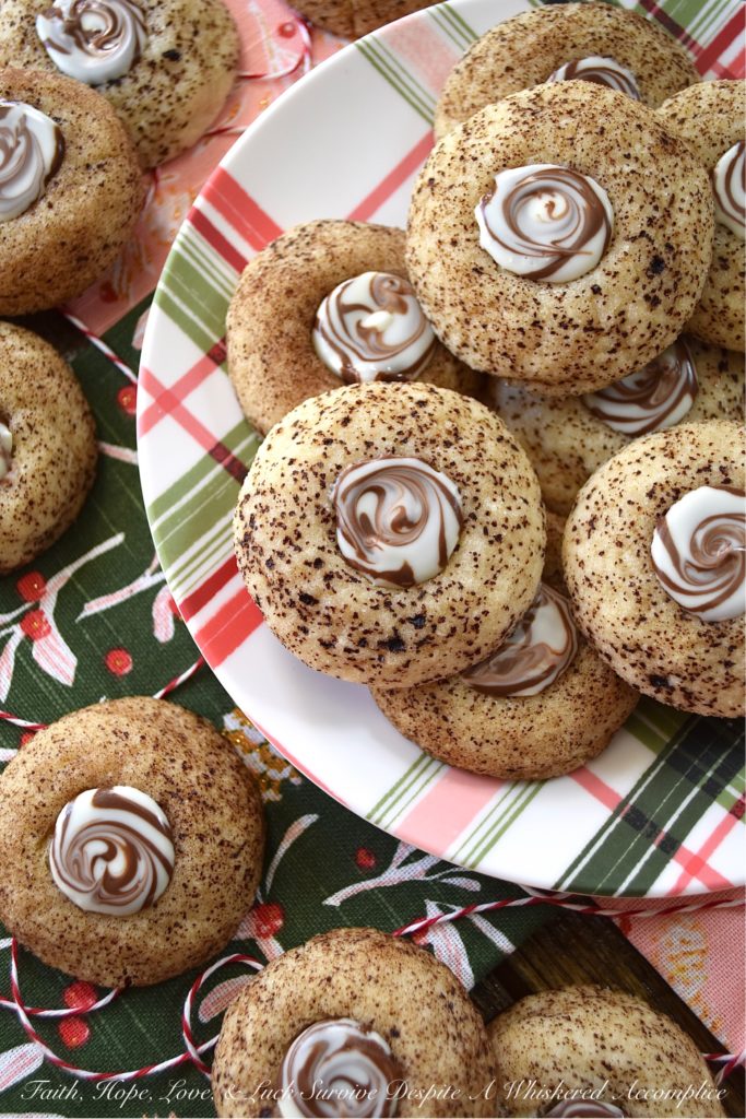 Cappuccino Swirl Butter Cookies - These amazing cappuccino swirl butter cookies are definitely a sweet treat your entire family will enjoy. They have just the right hint of coffee flavor, thanks to the espresso powder and sugar mixture they are rolled in before baking. And, once a Hershey's Kisses Hug is added to each cookie after baking, and then gently swirled after a few minutes of melting, these tasty, buttery, and delicious cookies definitely resemble an irresistible cup of fragrant cappuccino. Seriously, what's not to love bout this amazing cookie combination?