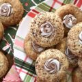 Cappuccino Swirl Butter Cookies - These amazing cappuccino swirl butter cookies are definitely a sweet treat your entire family will enjoy. They have just the right hint of coffee flavor, thanks to the espresso powder and sugar mixture they are rolled in before baking. And, once a Hershey's Kisses Hug is added to each cookie after baking, and then gently swirled after a few minutes of melting, these tasty, buttery, and delicious cookies definitely resemble an irresistible cup of fragrant cappuccino. Seriously, what's not to love bout this amazing cookie combination?