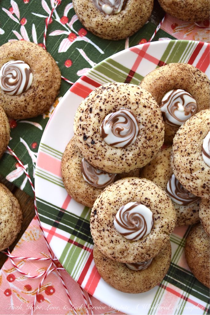 Cappuccino Swirl Butter Cookies - These amazing cappuccino swirl butter cookies are definitely a sweet treat your entire family will enjoy. They have just the right hint of coffee flavor, thanks to the espresso powder and sugar mixture they are rolled in before baking. And, once a Hershey's Kisses Hug is added to each cookie after baking, and then gently swirled after a few minutes of melting, these tasty, buttery, and delicious cookies definitely resemble an irresistible cup of fragrant cappuccino. Seriously, what's not to love bout this amazing cookie combination?