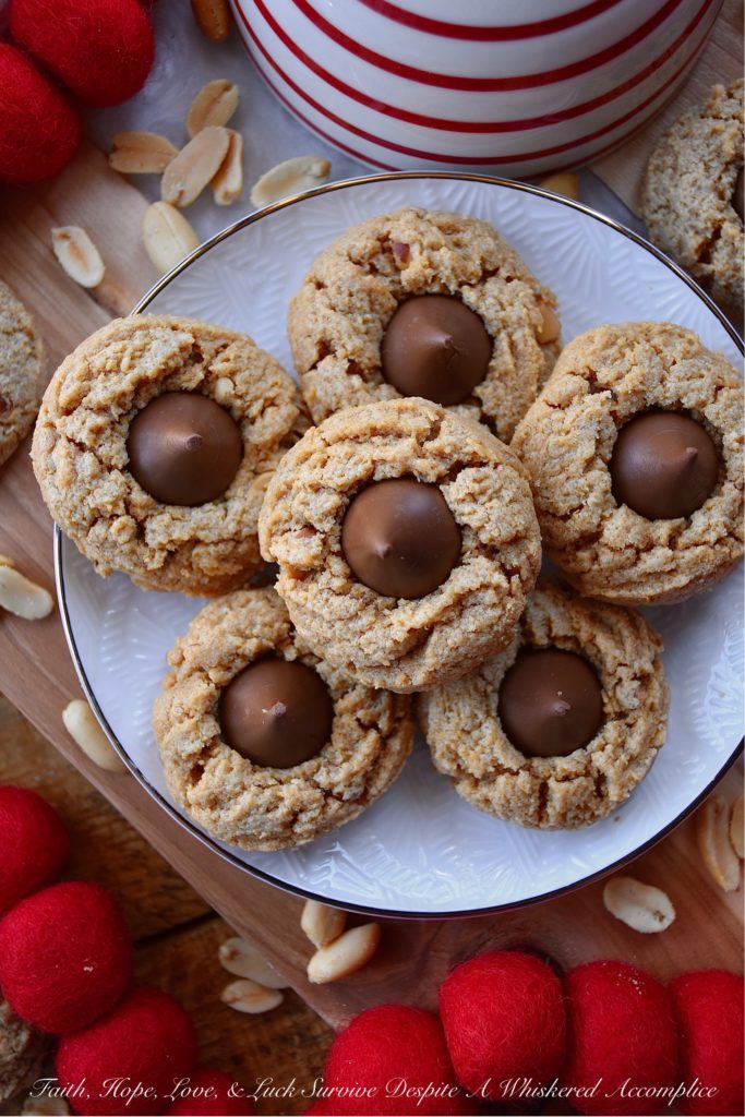 Flourless Chunky Peanut Butter Blossoms - After chocolate chip cookies, peanut butter cookies topped with Hersey's kisses, are probably one of the most-baked cookies of all time. So, I think it's pretty safe to say that these six-ingredient peanut butter blossom cookies, which are flourless and therefore gluten-free, will definitely win you over with their sweet flavor and crunchy texture.