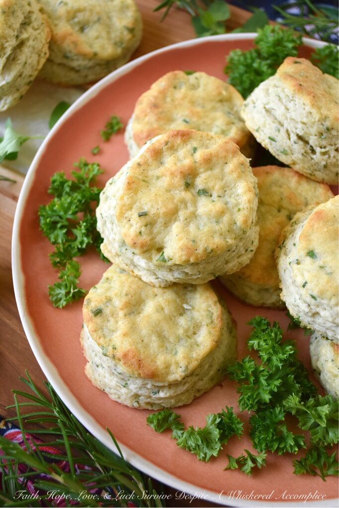 Buttery Fresh Herb Breakfast Biscuits - Is your herb garden overflowing with parsley, oregano, chives, rosemary, or basil? If so, these buttery biscuits, made with fresh herbs, are just what you need to bake for breakfast. They're flaky, warm, tender, fluffy, super-buttery, and even more amazing when served topped with your favorite fruity jam, thick preserves, or sweet jelly.