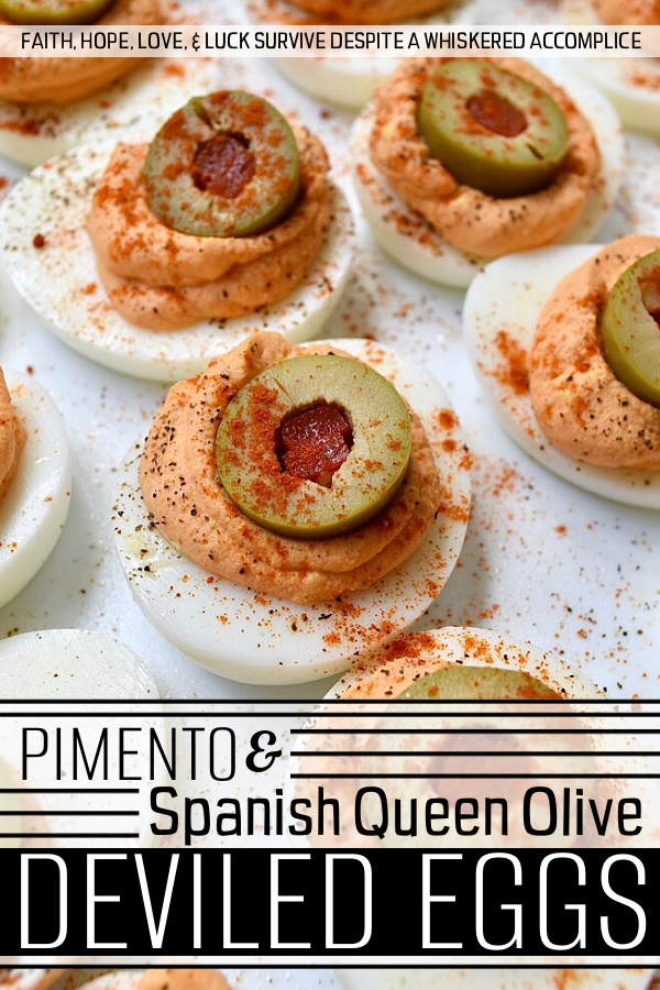Pimento & Spanish Queen Olive Deviled Eggs - A simple little jar of drained diced pimentos is the secret to these creamy deviled eggs topped with Spanish Queen Olives. They're colorful, flavorful, and a welcome change from most boring deviled egg recipes. With their gorgeous color and mild red pepper flavor, these pimento and green olive deviled eggs are sure to be a hit at your next party or cookout.