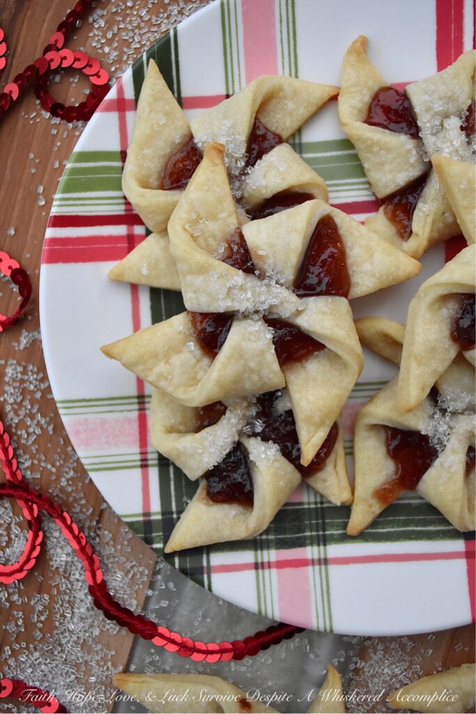 Sugar Plum Pinwheel Cookies - These whimsical sugar plum pinwheel cookies are the perfect cookie recipe to help make your cookie tray or platter really stand out this holiday season. And since the cookie dough for this large-batch cookie recipe is very similar to pie dough and extremely easy to work with, why not spend a little extra time this year to impress your friends and family with these charming plum preserve-filled holiday cookies?