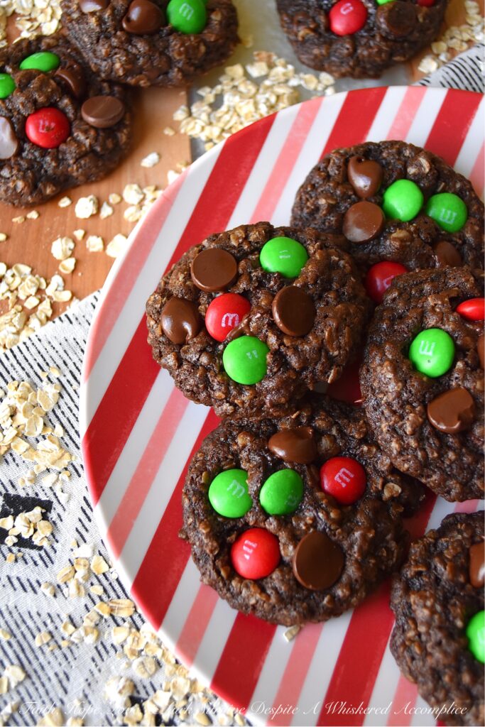 Chocolate Fudge Brownie Oatmeal M&M Cookies - When you can’t decide between an oatmeal cookie, a chocolate fudge brownie, or a handful of M&M’s, bake up a batch of these Chocolate Fudge Brownie Oatmeal M&M Cookies. You can satisfy all of your cravings with one rich, delicious, and super-chocolatey cookie and spread a little bit of seasonal cheer with the addition of festive holiday M&M’s.