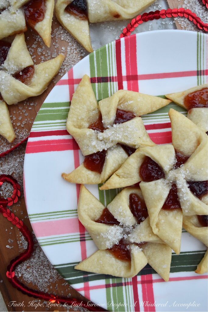 Sugar Plum Pinwheel Cookies - These whimsical sugar plum pinwheel cookies are the perfect cookie recipe to help make your cookie tray or platter really stand out this holiday season. And since the cookie dough for this large-batch cookie recipe is very similar to pie dough and extremely easy to work with, why not spend a little extra time this year to impress your friends and family with these charming plum preserve-filled holiday cookies?
