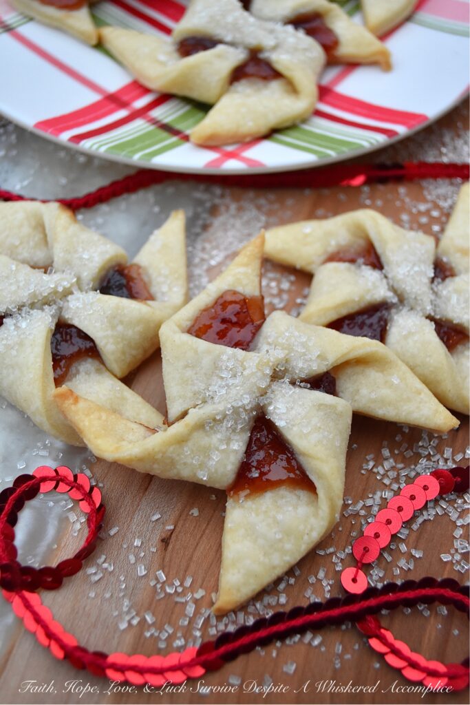 Sugar Plum Pinwheel Cookies - These whimsical sugar plum pinwheel cookies are the perfect cookie recipe to help make your cookie tray or platter really stand out this holiday season. And since the cookie dough for this large-batch cookie recipe is very similar to pie dough and extremely easy to work with, why not spend a little extra time this year to impress your friends and family with these charming plum preserve-filled holiday cookies?
