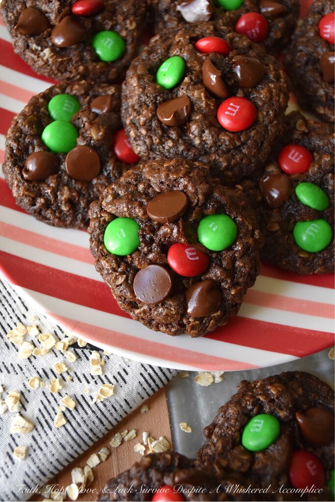Chocolate Fudge Brownie Oatmeal M&M Cookies - When you can’t decide between an oatmeal cookie, a chocolate fudge brownie, or a handful of M&M’s, bake up a batch of these Chocolate Fudge Brownie Oatmeal M&M Cookies. You can satisfy all of your cravings with one rich, delicious, and super-chocolatey cookie and spread a little bit of seasonal cheer with the addition of festive holiday M&M’s.
