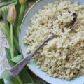 Garlicky Asiago Cauliflower Rice - The garlic seasoning and Asiago cheese in this garlicky cauliflower rice, really pack a punch, making this five-ingredient low-carb vegetable side dish a real weeknight winner.