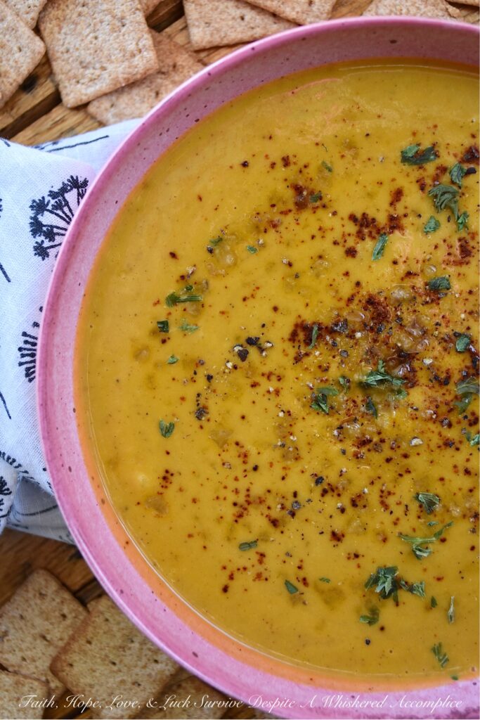Creamy Chili & Herb Sweet Potato & Onion Soup - This creamy vegetable and herb soup is a lovely budget-friendly and healthy meal option for a busy weeknight since it only requires one sweet potato, one sweet yellow onion, a carton of store-bought broth, and a few readily available kitchen herbs and seasonings. Add in some heavy whipping cream, half and half, or milk before blending to give this warm chili-spiced soup a creamy, smooth, and rich consistency.