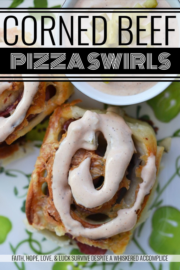 Corned Beef Pizza Swirls - St. Patrick's Day calls for a special appetizer, and these corned beef pizza swirls are that appetizer. They have just the right amount of corned beef lunchmeat and cheese rolled up inside of caraway seed-studded pizza dough. Add a swirl of homemade thousand island dressing on top and let the festive holiday celebration begin.