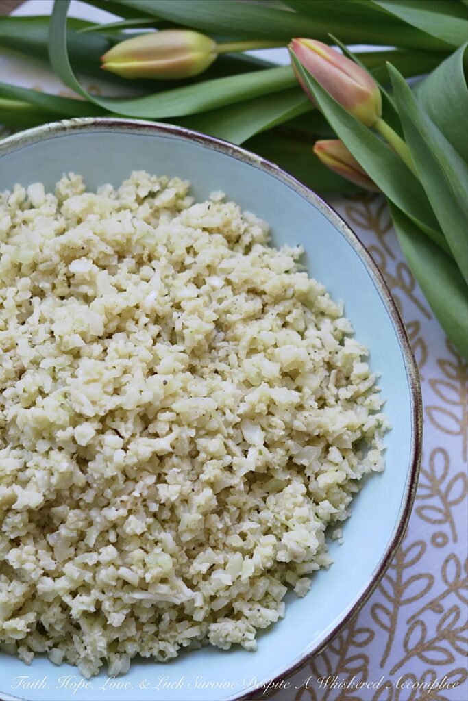Garlicky Asiago Cauliflower Rice - The garlic seasoning and Asiago cheese in this garlicky cauliflower rice, really pack a punch, making this five-ingredient low-carb vegetable side dish a real weeknight winner.