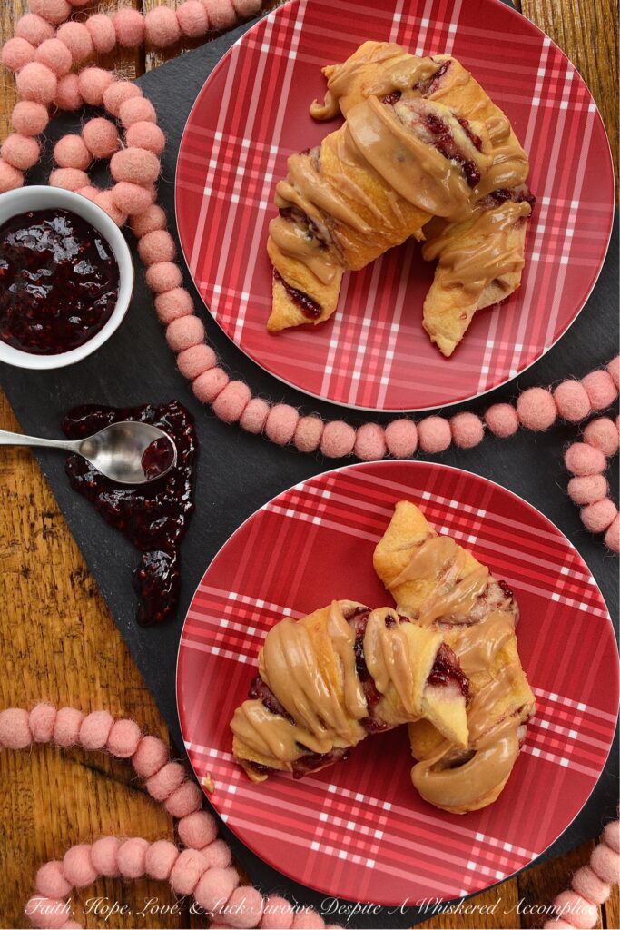 Raspberry & Peanut Butter Glazed Crescent Rolls - Are you a huge PB&J fan? Are peanut butter and jelly two of your favorite can't live without ingredients? If so, you're going to totally swoon over these raspberry and peanut butter glazed crescent rolls. I mean, how can you resist a crescent roll stuffed with raspberry preserves, jam, or jelly? Especially when it's topped with a smooth, creamy, and decadent peanut butter glaze.