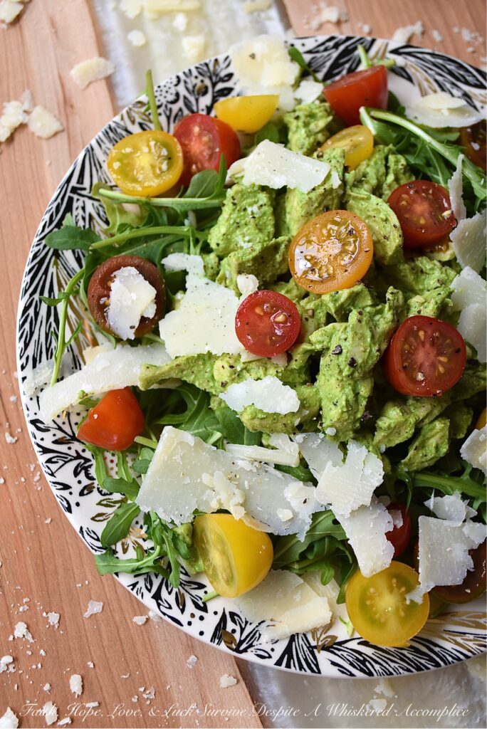 Basil-Dressed Chicken Salad with Tomatoes - This easy-to-assemble salad is the perfect weeknight meal for when you're craving something a little bit lighter. Its blend of peppery arugula and salty parmesan cheese pairs so well with the acidity of halved cherry or grape tomatoes and a sweet, creamy, and flavorful chicken salad made with a fresh basil dressing.
