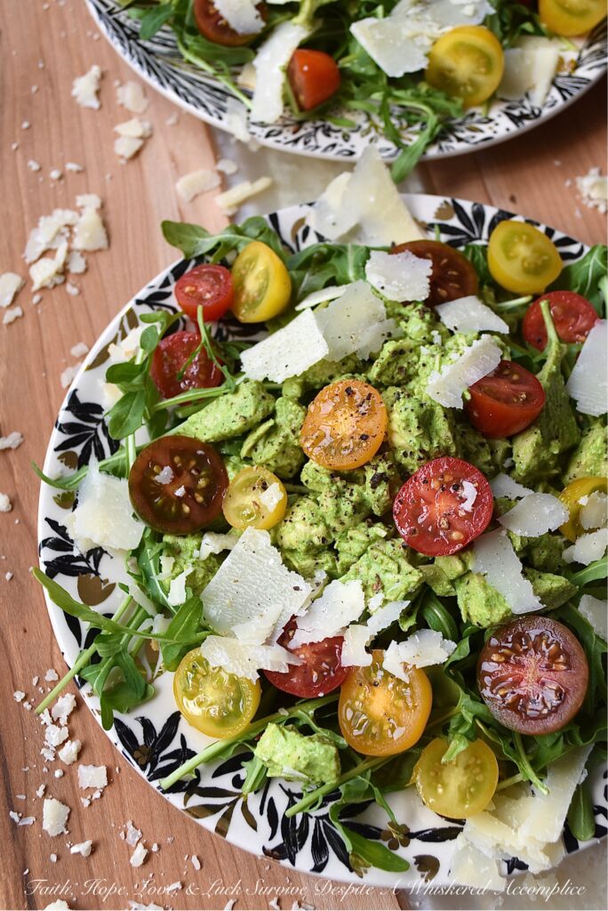 Basil-Dressed Chicken Salad with Tomatoes - This easy-to-assemble salad is the perfect weeknight meal for when you're craving something a little bit lighter. Its blend of peppery arugula and salty parmesan cheese pairs so well with the acidity of halved cherry or grape tomatoes and a sweet, creamy, and flavorful chicken salad made with a fresh basil dressing.