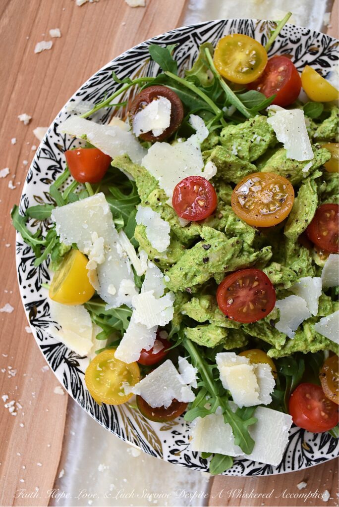 Basil-Dressed Chicken Salad with Tomatoes - This easy-to-assemble salad is the perfect weeknight meal for when you're craving something a little bit lighter. Its blend of peppery arugula and salty parmesan cheese pairs so well with the acidity of halved cherry or grape tomatoes and a sweet, creamy, and flavorful chicken salad made with a fresh basil dressing.