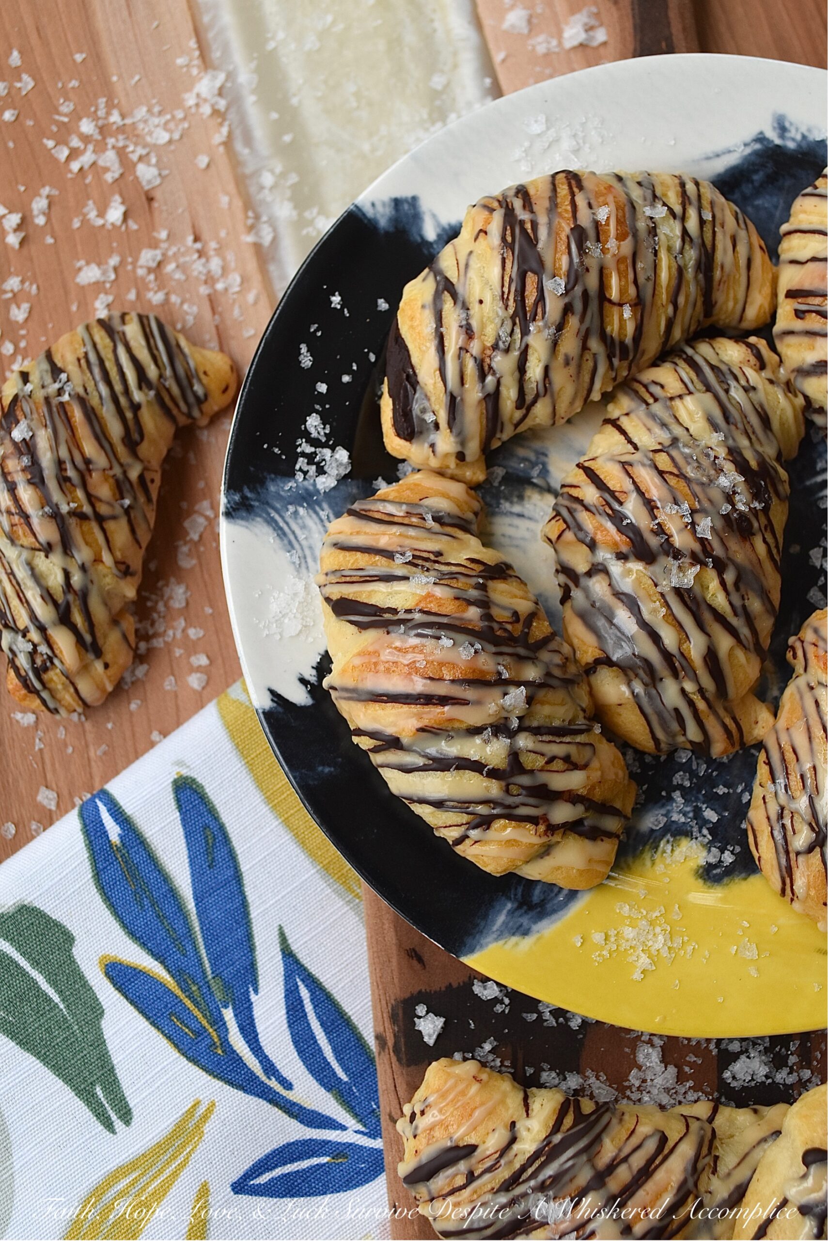 Chocolate Crescent Rolls with Baileys & Sea Salt - When you wake up and find yourself in need of a sweet treat but don't feel like spending all morning in the kitchen, these chocolate crescent rolls are just what you need. Store-bought crescent rolls are filled with chopped chocolate, baked until golden brown, and then drizzled with both additional melted chocolate and a sweet Baileys Irish Cream glaze. A little sprinkle of sea salt is the final and flavorful touch to help make this breakfast, brunch, or dessert treat simply irresistible.